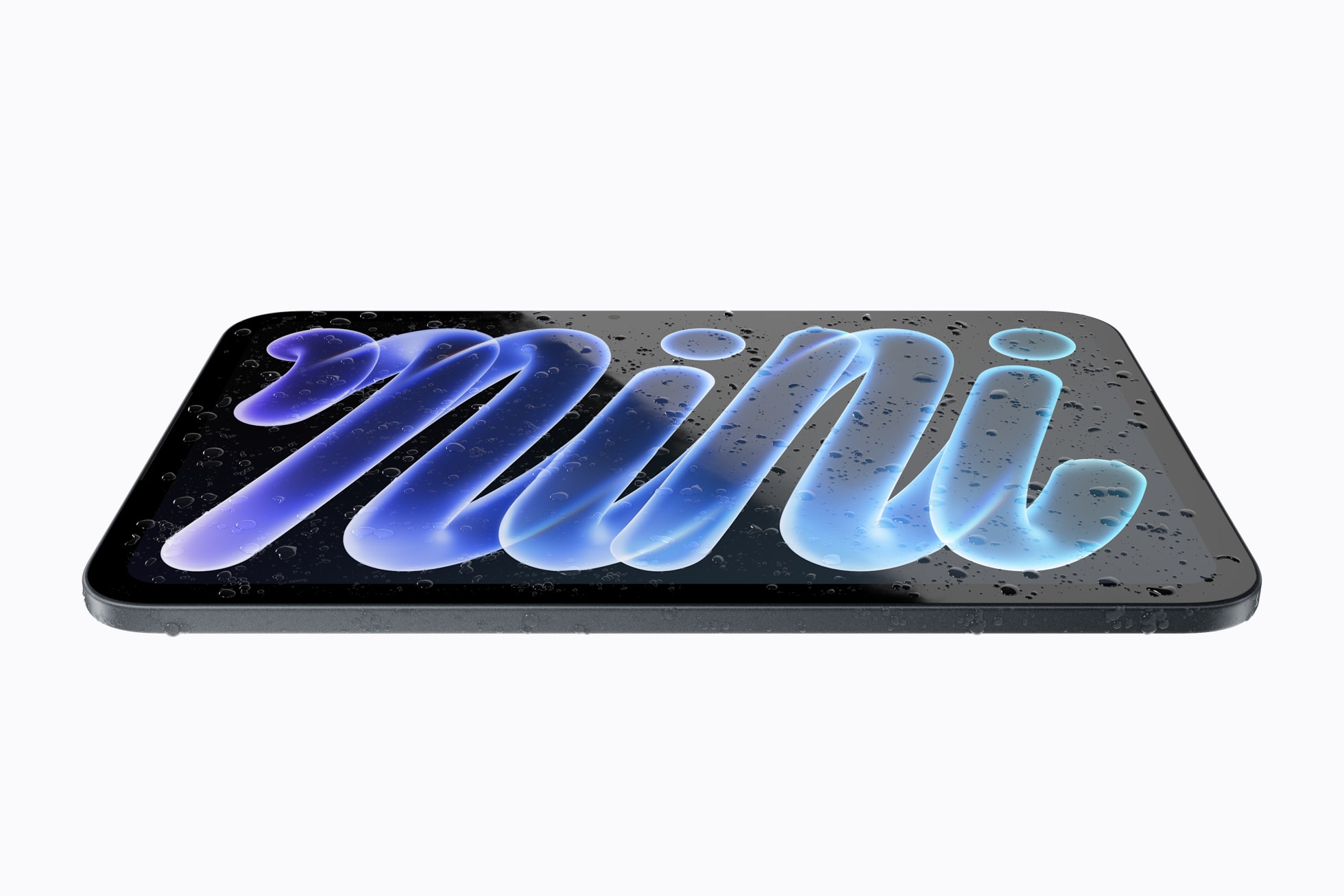 Product photo on a white background: an iPad mini lying flat, its body and screen covered in water droplets, the screen showing the word “mini” in blue-purple. Text: “mini” on the screen.