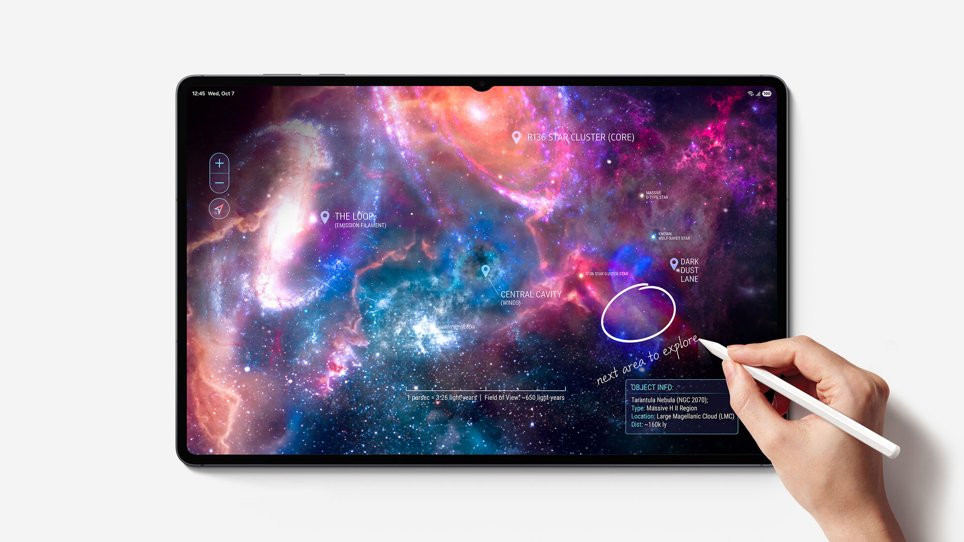 A hand holding an S Pen circles part of a nebula map on a tablet screen; text: R136 STAR CLUSTER (CORE), THE LOOP, CENTRAL CAVITY, DARK DUST LANE, handwritten note reading 'next area to explore', status bar 12:45 Wed, Oct 7